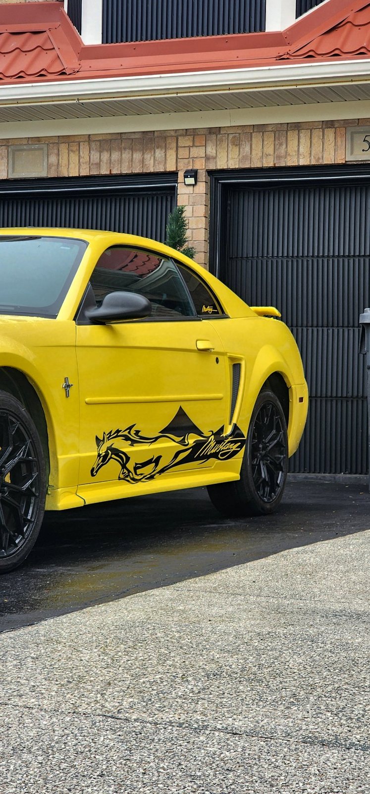 Running horse side decal on a yellow Ford Mustang