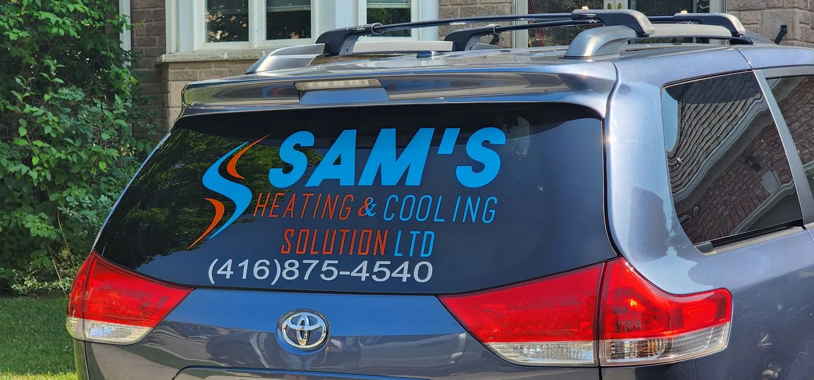 Sam's Heating & Cooling van with rear window lettering
