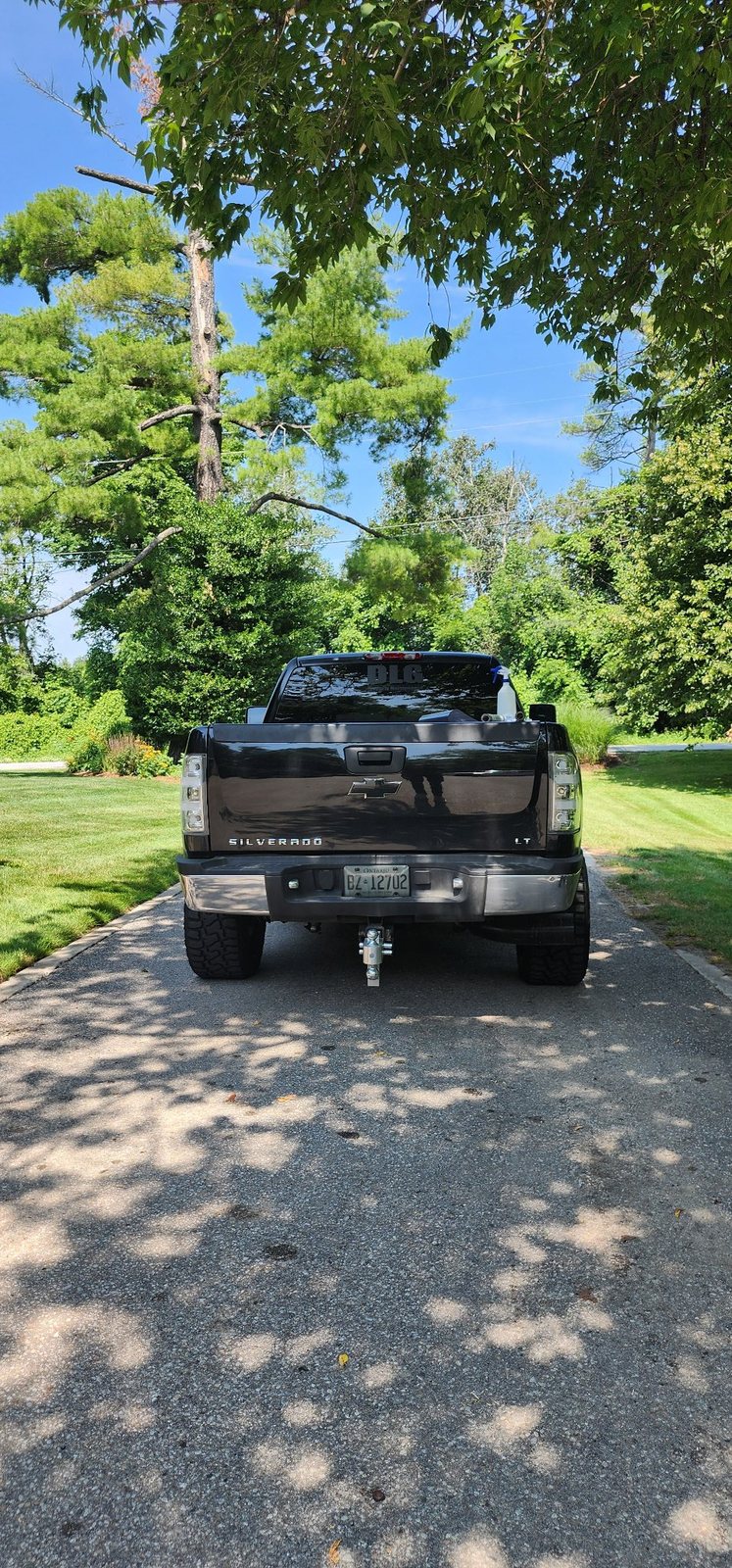 Full rear view of a truck with tinted taillights and window decal
