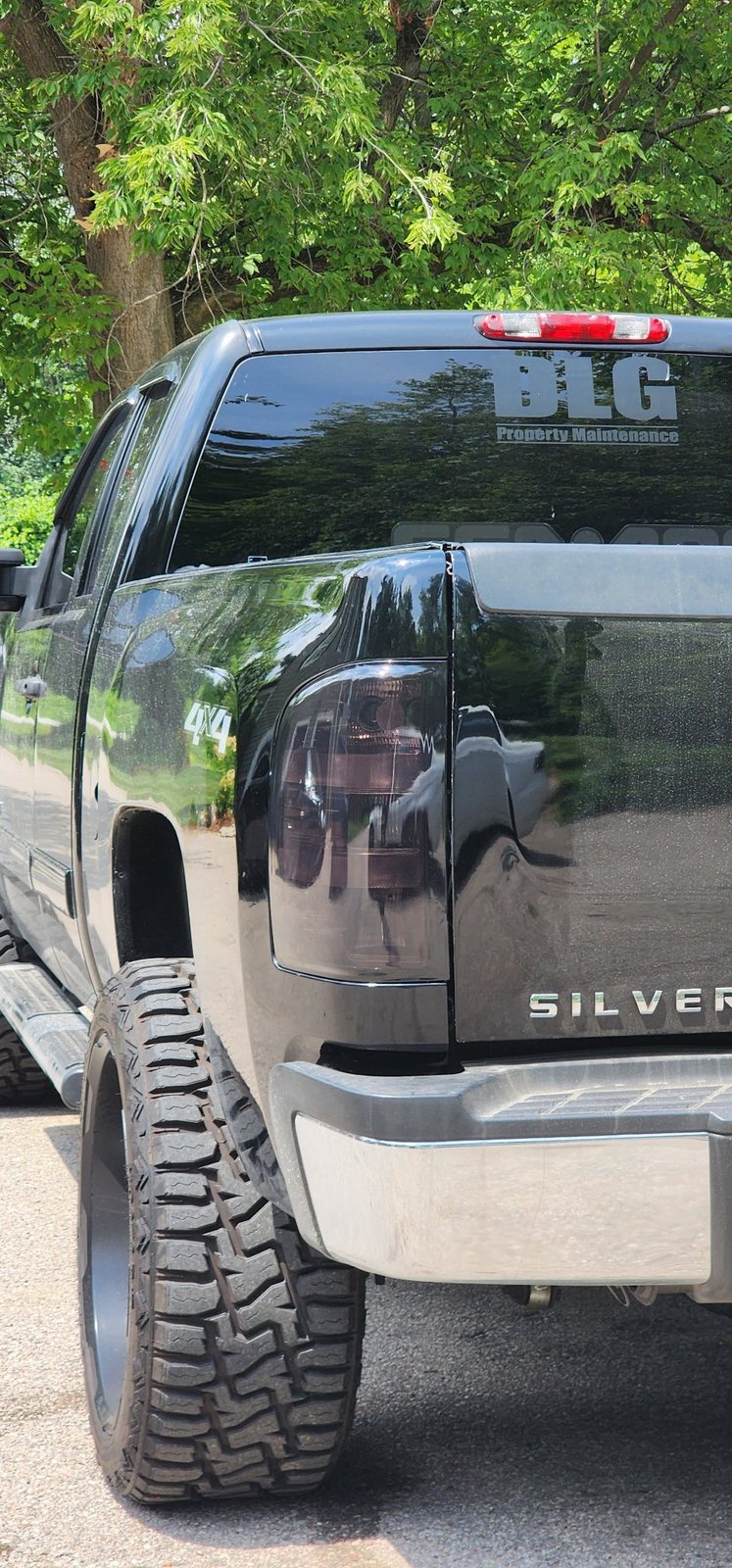 Side profile of a black Silverado with smoked taillight tint