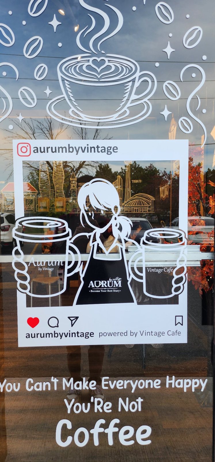 Coffee shop window with white vinyl artwork and lettering